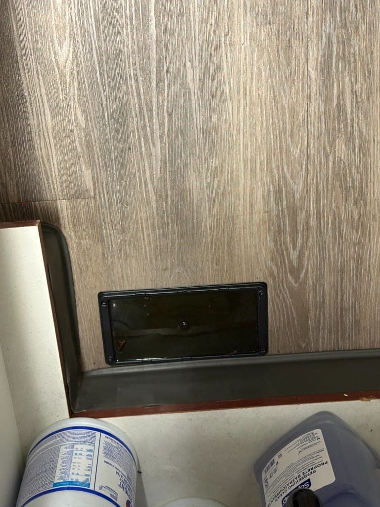 Insect monitoring station installed inside a cabinet beneath a sink